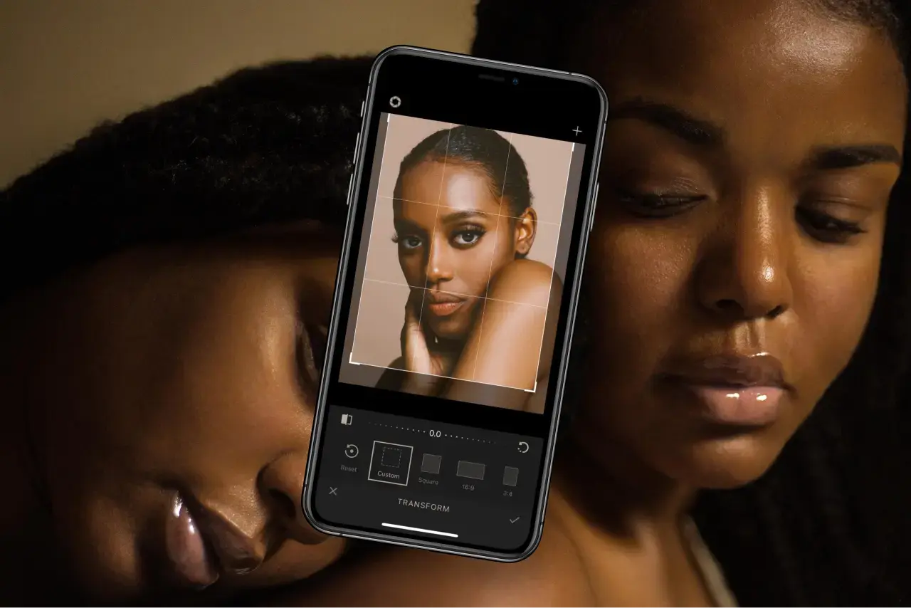 Two women with phone displaying the app's crop tool